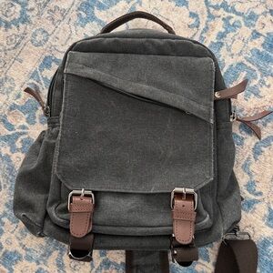Classic Charcoal Canvas Crossover 1-Strap Backpack with Brown Accents.